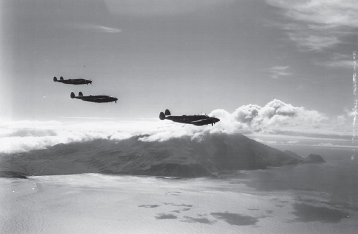 Three U.S. planes fly in front of Kiska Volcano, which is obscured by clouds, during the U.S.-Canadian invasion of Kiska Island on August 15, 1943. It turned out that the Japanese had evacuated it several weeks earlier undetected by U.S. forces. (Courtesy NARA)