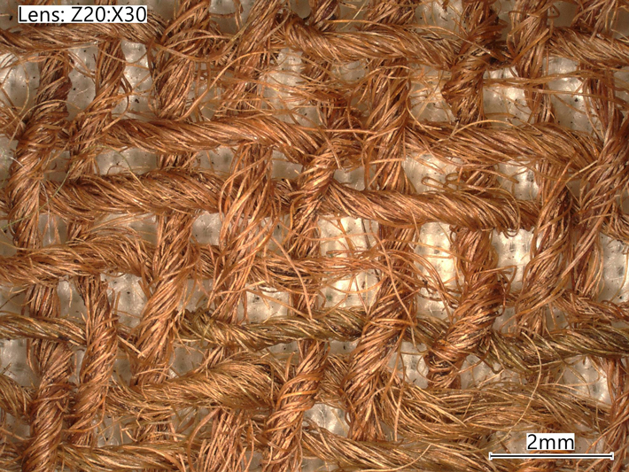 Threads of a woolen piece of fabric that is the oldest known example of true tartan ever discovered in Scotland, likely dating to the first half of the sixteenth century, shown magnified 30 times. (National Museums Scotland)