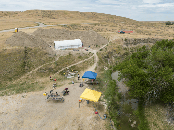 An aerial view of the La Prele excavations shows a white tent covering the area actively under investigation. 