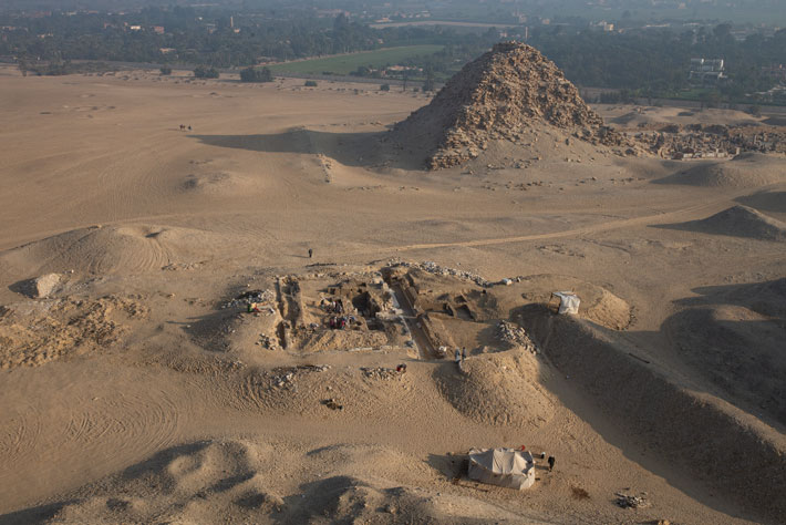  The excavation of Kairsu’s tomb seen from the top of the pyramid of the 5th Dynasty pharaoh Nefirirkare (r. ca. 2446-2438 B.C.). The pyramid of Sahure (r. ca. 2458-2446 B.C.) stands in the background. 